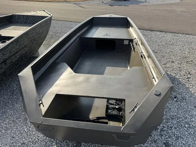Slide: The Image of 2025 Edge Duck Boats 550 SPORTSMAN, open interior, parked on gravel. - 7