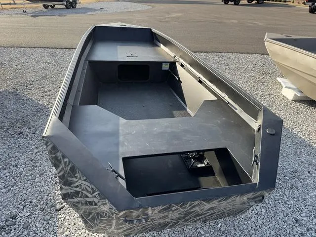 Slide: The Image of 2025 Edge Duck Boats 550 SPORTSMAN, camo design, parked on gravel. - 4