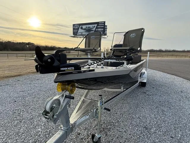 Slide: The Image of 2022 Excel Boats Bay Pro 220 on trailer, featuring Minn Kota motor, at sunset. - 4