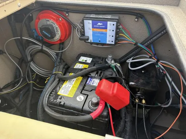 Slide: The Image of 2022 Excel Boats Bay Pro 220 battery compartment with wiring and electrical components. - 8