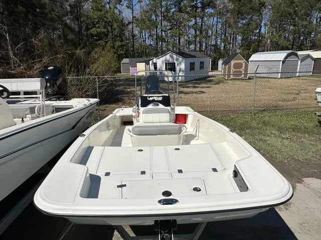 Slide: The Image of 2024 Mako Pro Skiff 15 CC boat with 60HP engine, parked outdoors. - 3