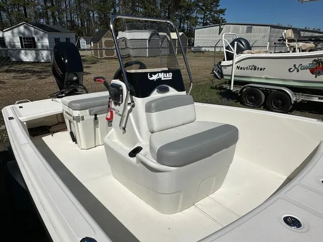 Slide: The Image of 2024 Mako Pro Skiff 15 CC boat with 60HP engine, featuring a central console and seating. - 4