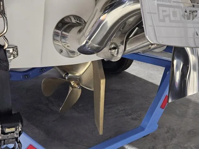 Slide: The Image of 2025 Malibu 23 LSV boat propeller and exhaust system on a trailer. - 13