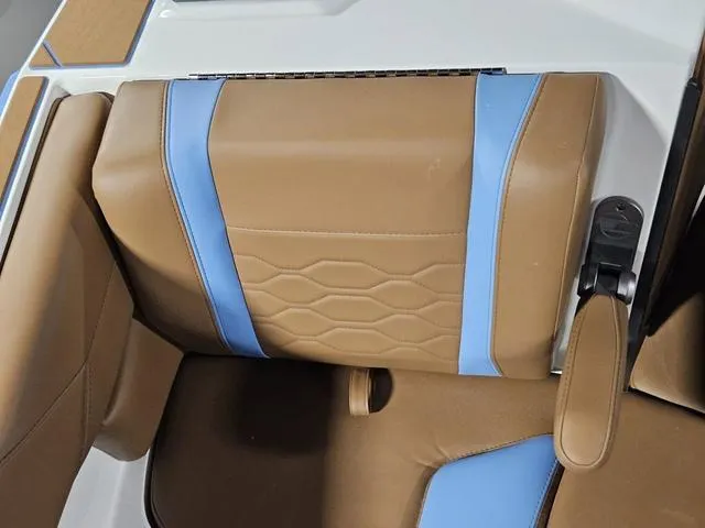 Slide: The Image of 2025 Malibu 23 LSV boat seat with tan and blue upholstery design. - 21