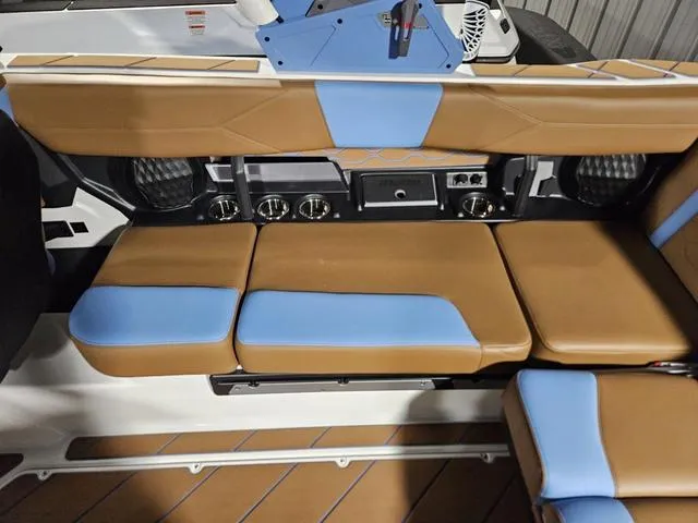 Slide: The Image of 2025 Malibu 23 LSV interior with tan and blue seating, featuring audio controls and speakers. - 25