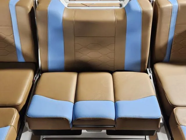Slide: The Image of 2025 Malibu 23 LSV boat seats with brown and blue upholstery design. - 32