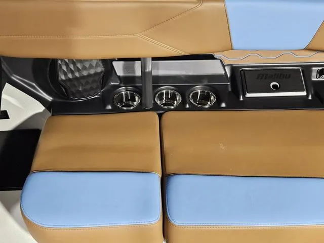 Slide: The Image of Interior seating of 2025 Malibu 23 LSV boat with cup holders and storage. - 33