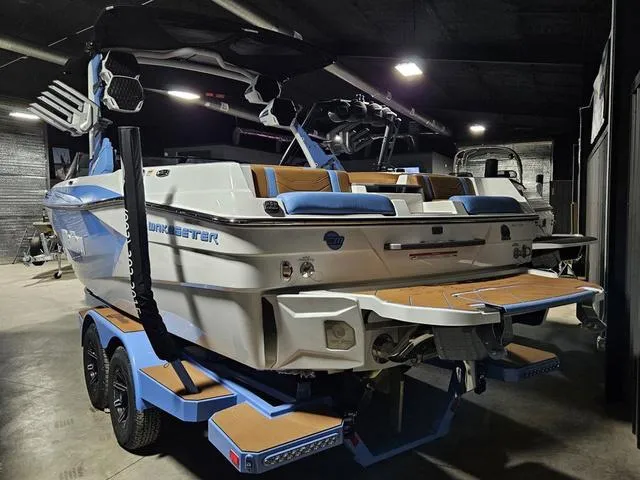 Slide: The Image of 2025 Malibu 23 LSV boat in a dimly lit garage, showcasing sleek design and modern features. - 4