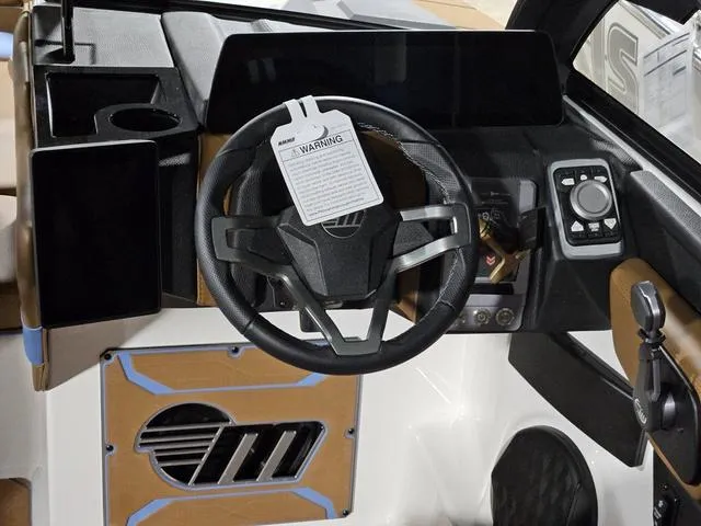 Slide: The Image of 2025 Malibu 23 LSV boat dashboard with steering wheel and control panel. - 42