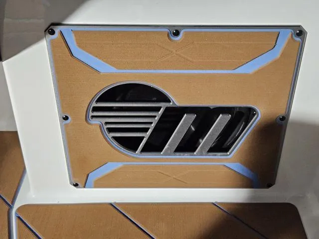 Slide: The Image of 2025 Malibu 23 LSV boat detail with stylish emblem and sleek design elements. - 46