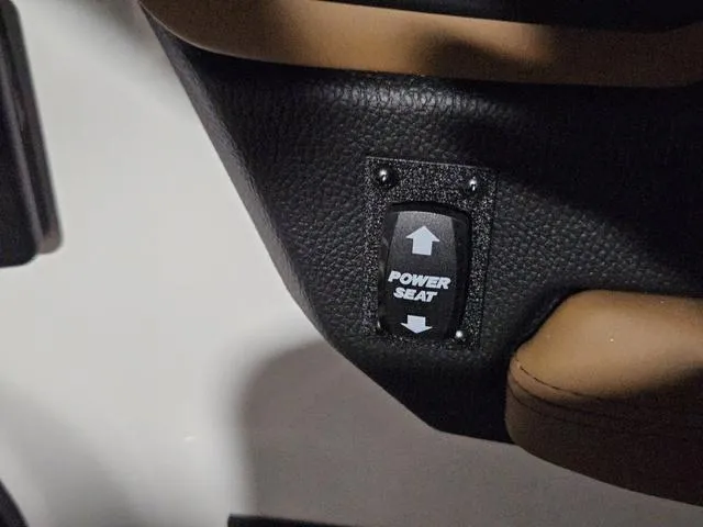 Slide: The Image of Power seat control in 2025 Malibu 23 LSV boat, featuring black leather upholstery. - 48