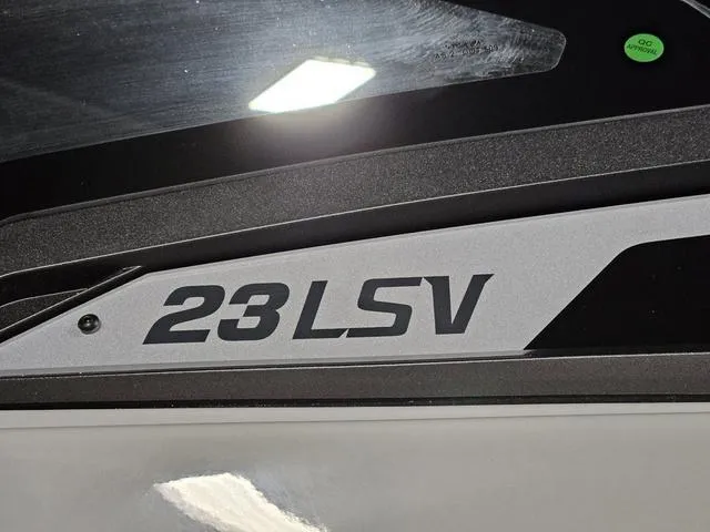 Slide: The Image of Close-up of 2025 Malibu 23 LSV boat model logo on sleek surface. - 6