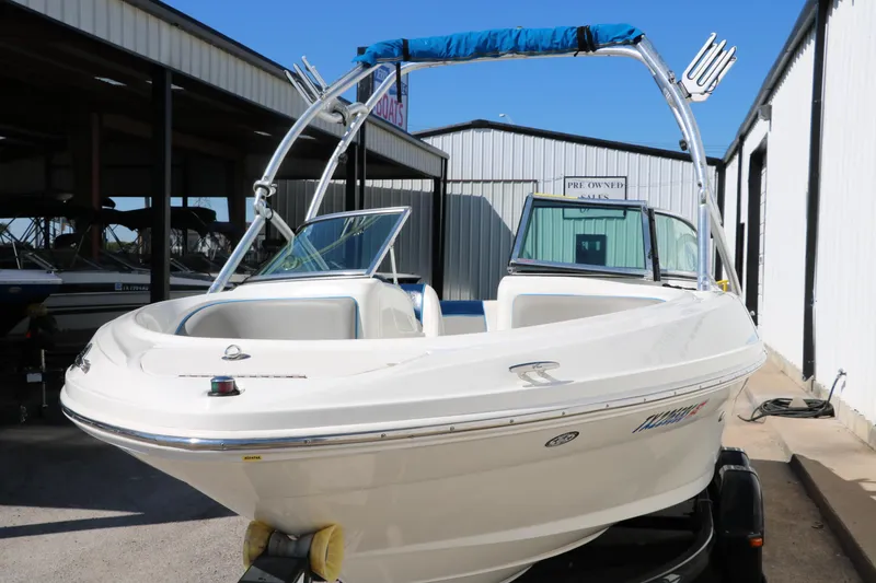 Slide: The Image of 2011 Sea Ray 205 Sport boat with wakeboard tower, parked in a marina. - 10