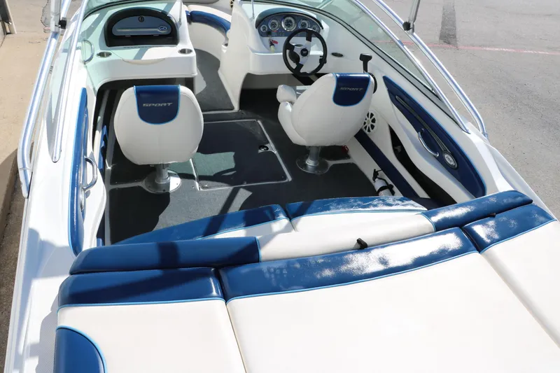 Slide: The Image of Interior of 2011 Sea Ray 205 Sport boat with white and blue seating. - 18