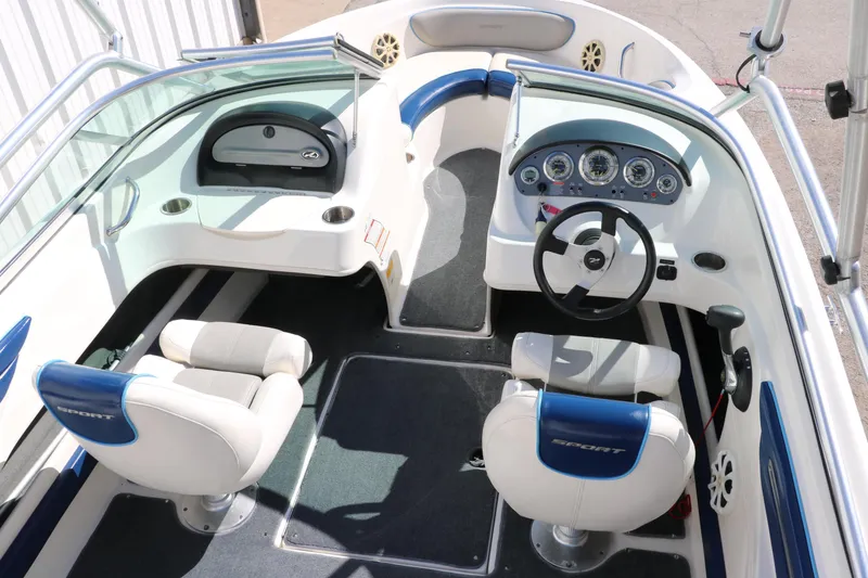 Slide: The Image of 2011 Sea Ray 205 Sport boat interior with dual seats and dashboard controls. - 19