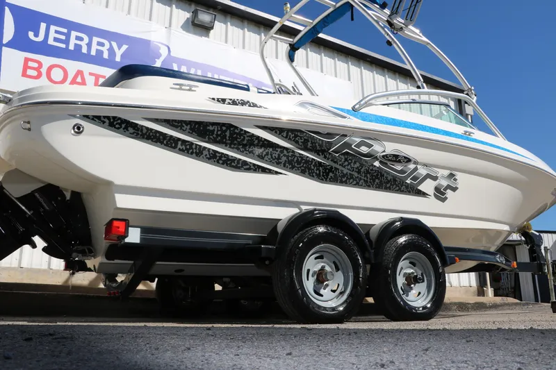 Slide: The Image of 2011 Sea Ray 205 Sport boat on trailer, displayed outside a dealership. - 2