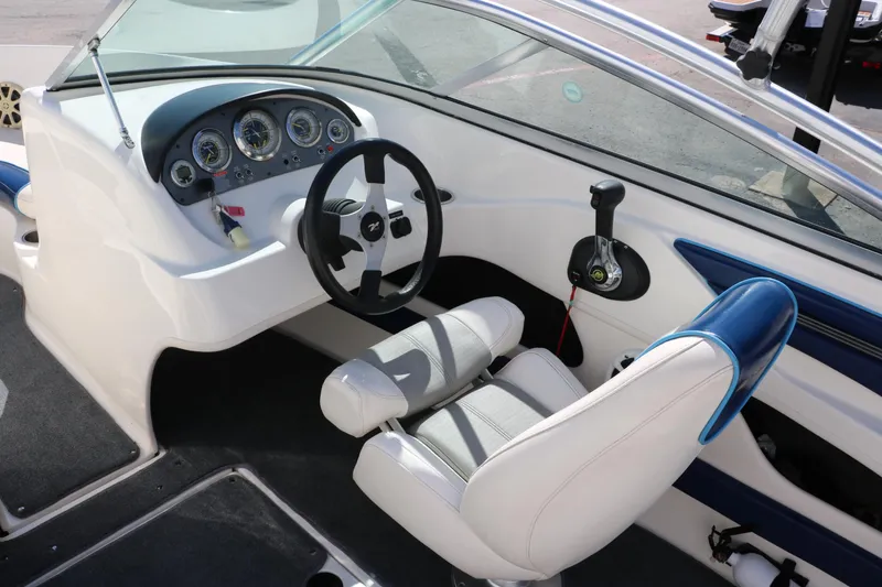 Slide: The Image of 2011 Sea Ray 205 Sport boat seat with blue and white upholstery. - 26