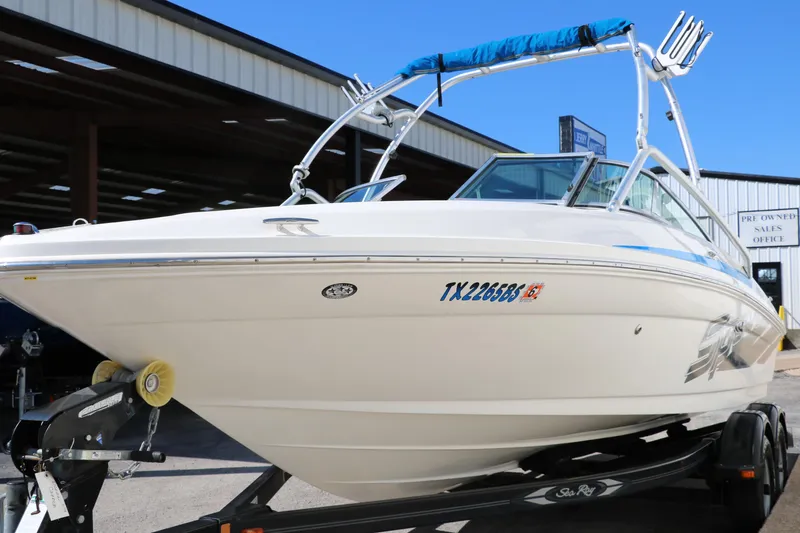 Slide: The Image of 2011 Sea Ray 205 Sport boat on trailer, displayed outdoors. - 8