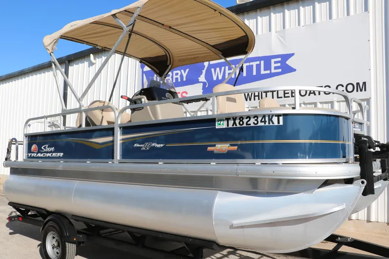 Slide: The Image of 2023 Sun Tracker 18 BASS BUGGY pontoon boat with canopy on trailer. - 11