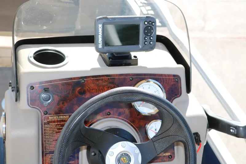 Slide: The Image of 2023 Sun Tracker 18 Bass Buggy dashboard with steering wheel and Lowrance fish finder. - 28