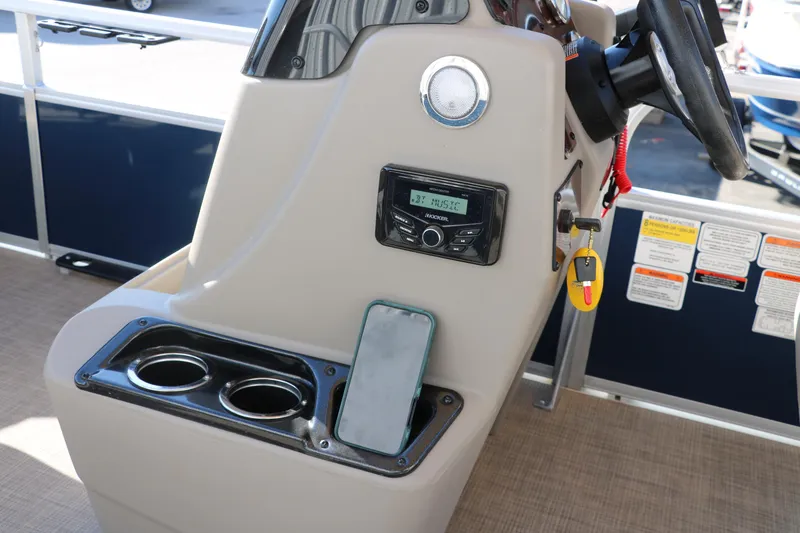 Slide: The Image of 2023 Sun Tracker 18 BASS BUGGY console with steering wheel, cup holders, and control panel. - 30