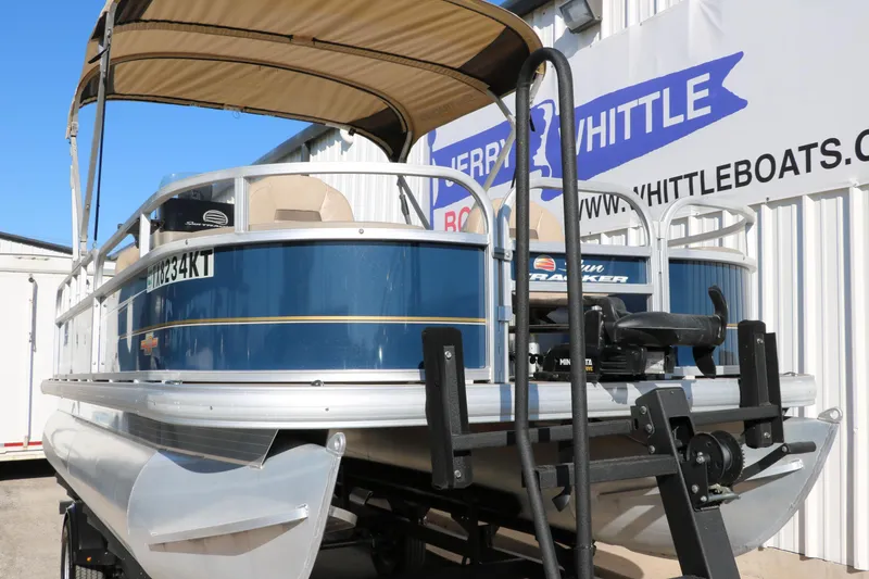 Slide: The Image of 2023 Sun Tracker 18 BASS BUGGY pontoon boat with canopy, displayed at dealership. - 9