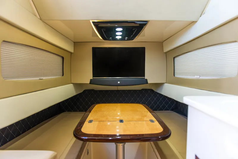 Slide: The Image of Luxurious interior of 2017 Scout 420 LXF yacht with TV and wooden table. - 12