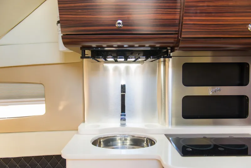 Slide: The Image of 2017 Scout 420 LXF interior kitchen with sink, stove, and wooden cabinets. - 14