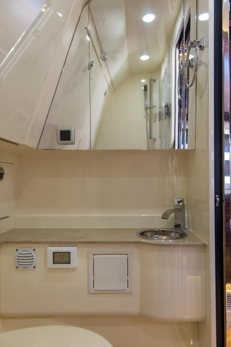 Slide: The Image of 2017 Scout 420 LXF boat interior with modern bathroom fixtures and sleek design. - 20