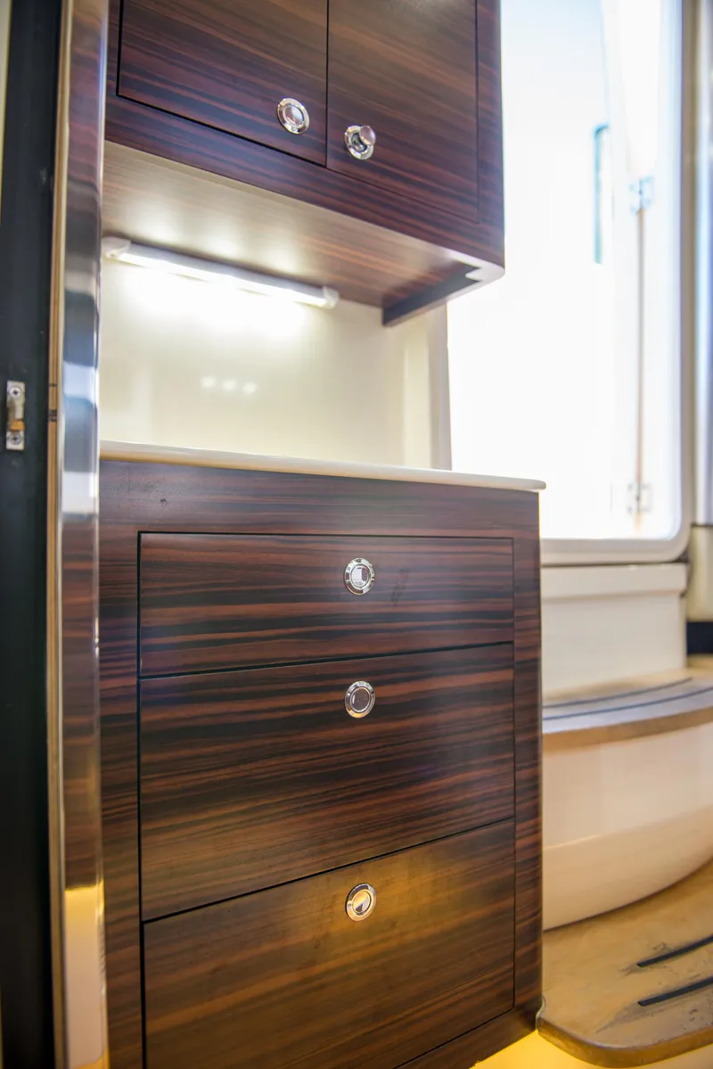 Slide: The Image of 2017 Scout 420 LXF interior with sleek wooden cabinetry and modern design. - 21