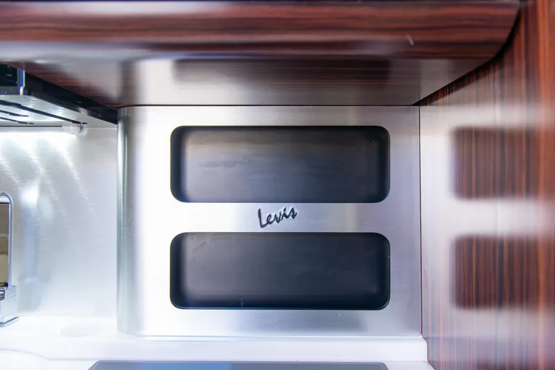 Slide: The Image of Interior detail of 2017 Scout 420 LXF boat, featuring sleek wood and metal finishes. - 22