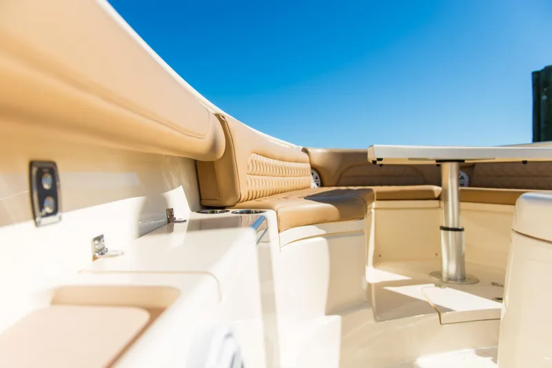 Slide: The Image of Luxurious seating area on a 2017 Scout 420 LXF boat under clear blue skies. - 25