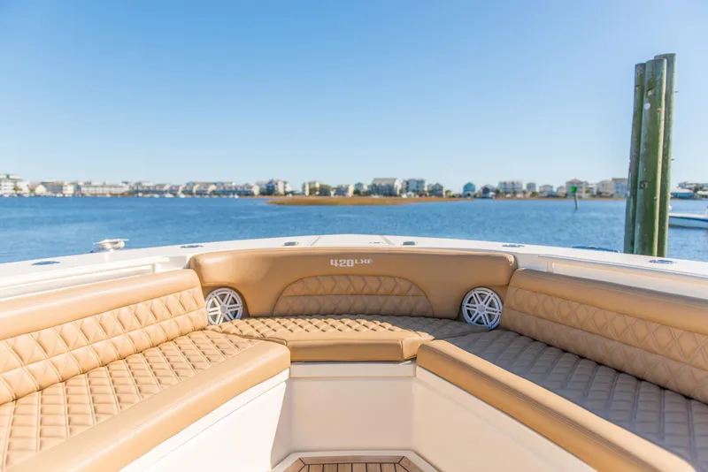 Slide: The Image of Luxurious seating on 2017 Scout 420 LXF boat with waterfront view. - 30