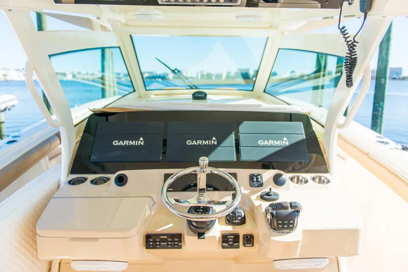 Slide: The Image of 2017 Scout 420 LXF boat dashboard with Garmin navigation displays. - 31