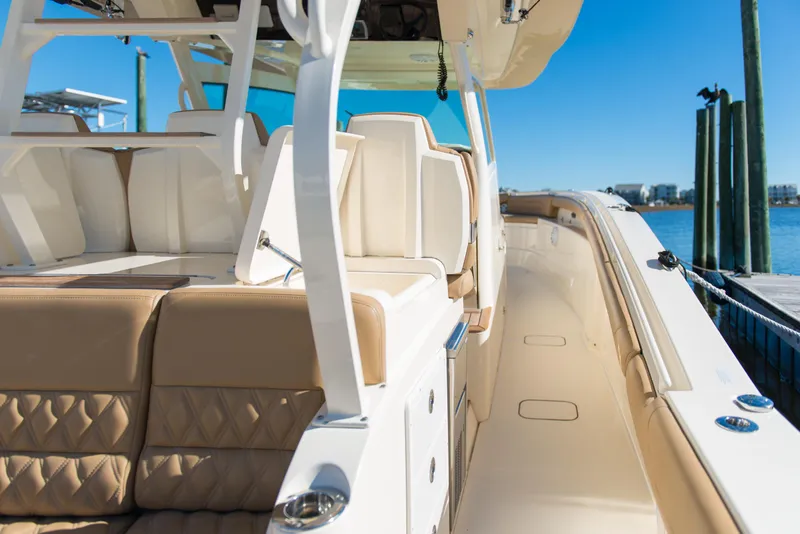 Slide: The Image of 2017 Scout 420 LXF luxury boat interior with beige seating and sleek design. - 38