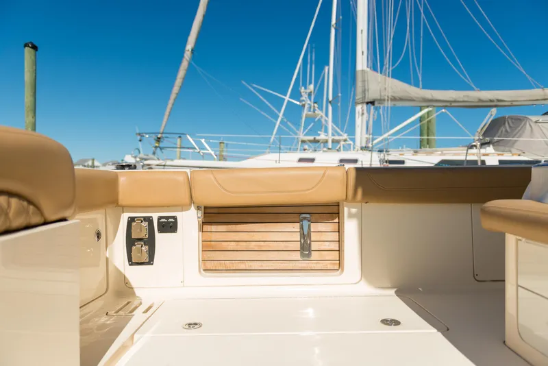 Slide: The Image of 2017 Scout 420 LXF boat interior with tan seating and wooden accents. - 41