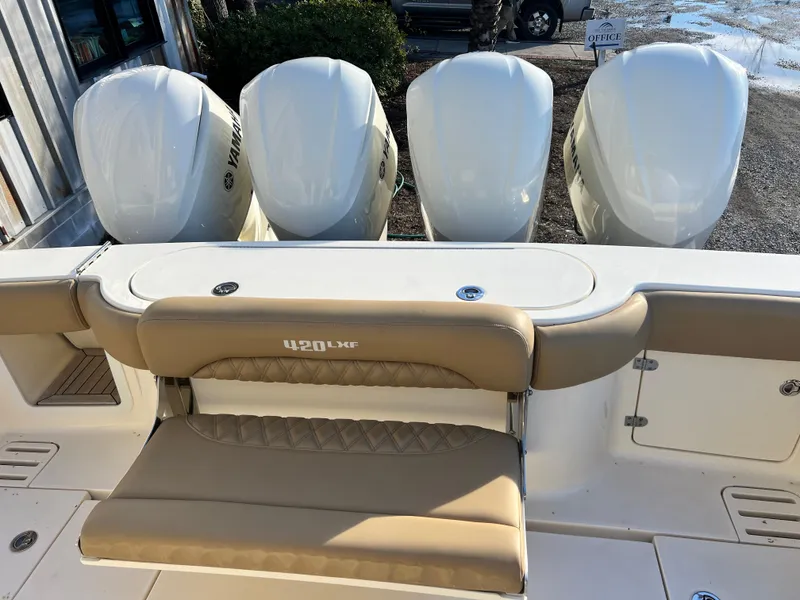 Slide: The Image of 2017 Scout 420 LXF boat with four Yamaha outboard engines and tan seating. - 9