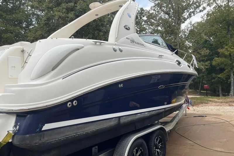 Slide: The Image of 2005 Sea Ray 280 Sundancer boat on trailer, parked outdoors. - 18