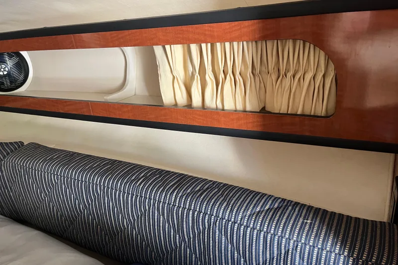Slide: The Image of Interior of 2005 Sea Ray Sundancer 280 with wood paneling and striped upholstery. - 23