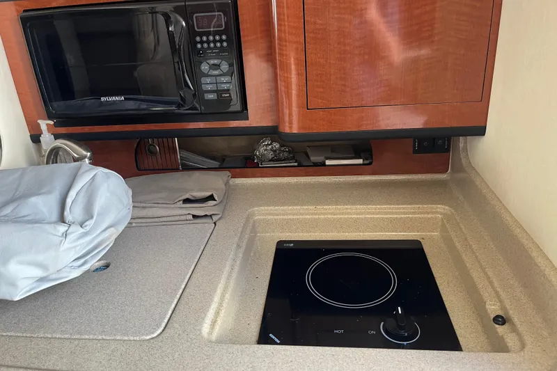 Slide: The Image of 2005 Sea Ray Sundancer 280 galley with microwave and electric cooktop. - 27