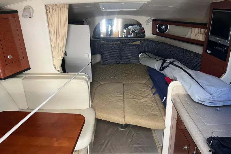 Slide: The Image of Interior of 2005 Sea Ray Sundancer 280 cabin with seating and bedding area. - 29