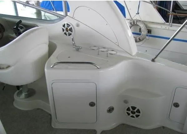 Slide: The Image of 2005 Sea Ray 280 Sundancer interior seating, white upholstery, elegant design. - 3