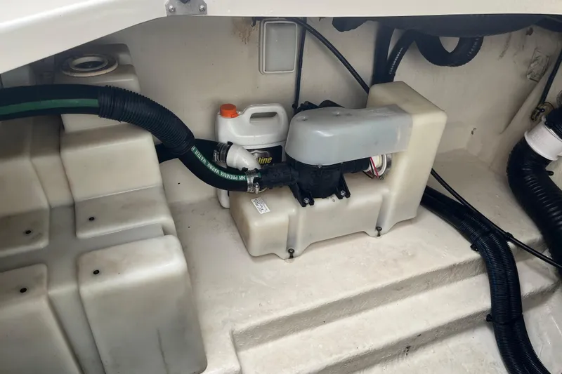 Slide: The Image of Engine compartment of 2005 Sea Ray 280 Sundancer with hoses and fluid container. - 34