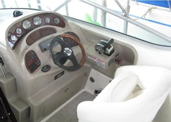 Slide: The Image of 2005 Sea Ray 280 Sundancer helm with steering wheel and control panel. - 5