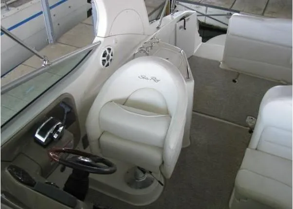 Slide: The Image of 2005 Sea Ray 280 Sundancer boat interior with white seating and dock view. - 8