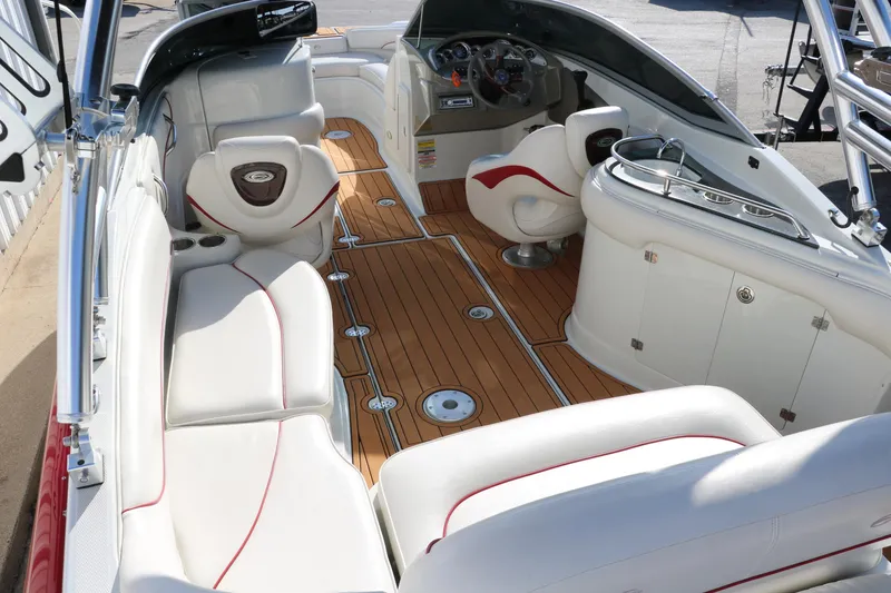Slide: The Image of 2007 Crownline 240 EX boat interior with white seating and wood flooring. - 14