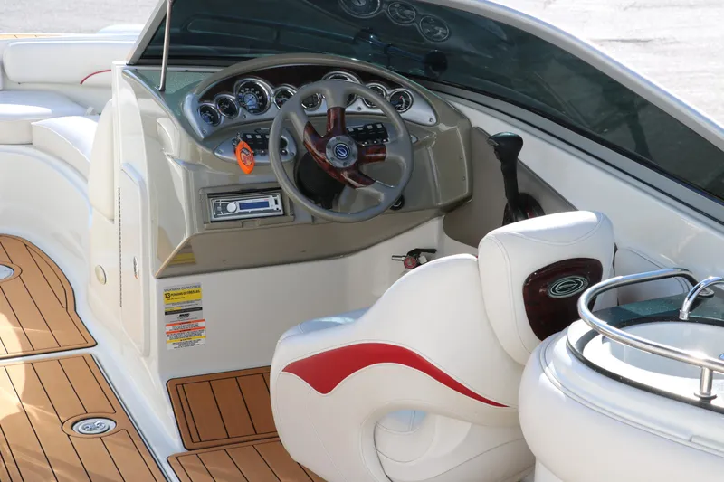 Slide: The Image of 2007 Crownline 240 EX boat interior with steering wheel and dashboard controls. - 15