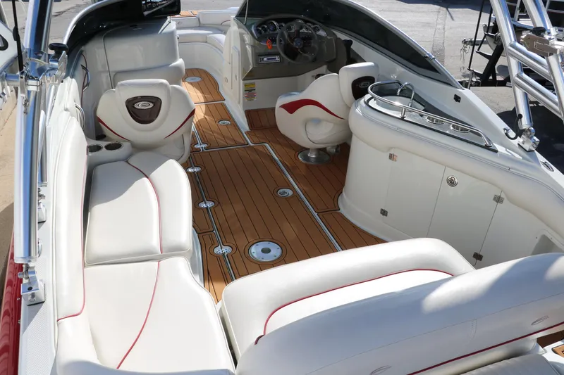 Slide: The Image of 2007 Crownline 240 EX boat interior with white seating and wood flooring. - 17