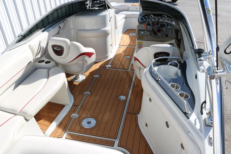 Slide: The Image of 2007 Crownline 240 EX boat interior with wood flooring and white seating. - 20