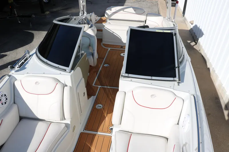 Slide: The Image of 2007 Crownline 240 EX boat interior with white seating and wooden deck. - 22